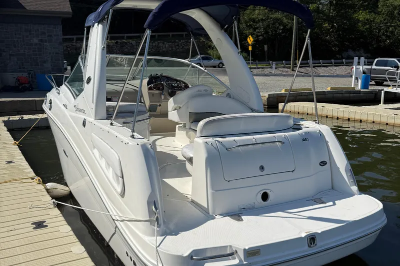 Slide: The Image of 2007 Sea Ray 260 Sundancer docked, showcasing sleek design and spacious interior. - 3