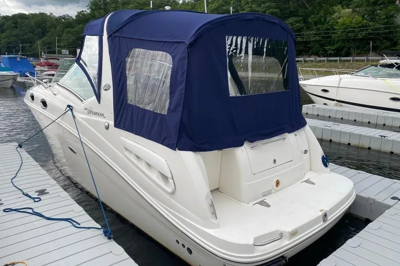 Slide: The Image of 2007 Sea Ray 260 Sundancer docked with blue canopy, rear view. - 4