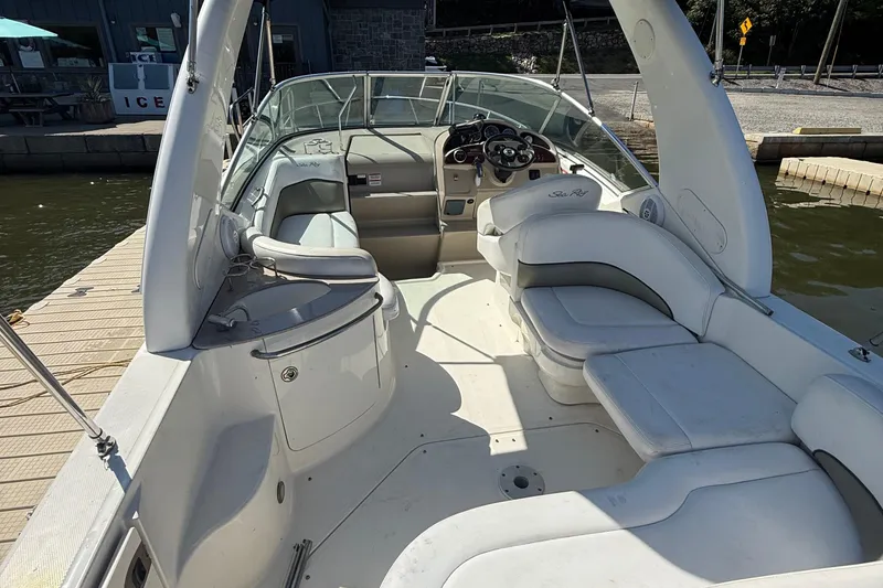 Slide: The Image of 2007 Sea Ray 260 Sundancer boat interior with seating and steering wheel at dock. - 5