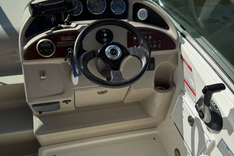 Slide: The Image of Steering console of a 2007 Sea Ray 260 Sundancer boat with gauges and controls. - 7