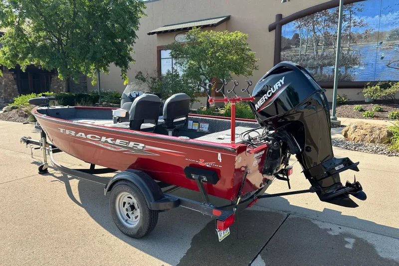 Slide: The Image of 2021 Tracker Super Guide V 16 SC boat with Mercury engine on trailer. - 2