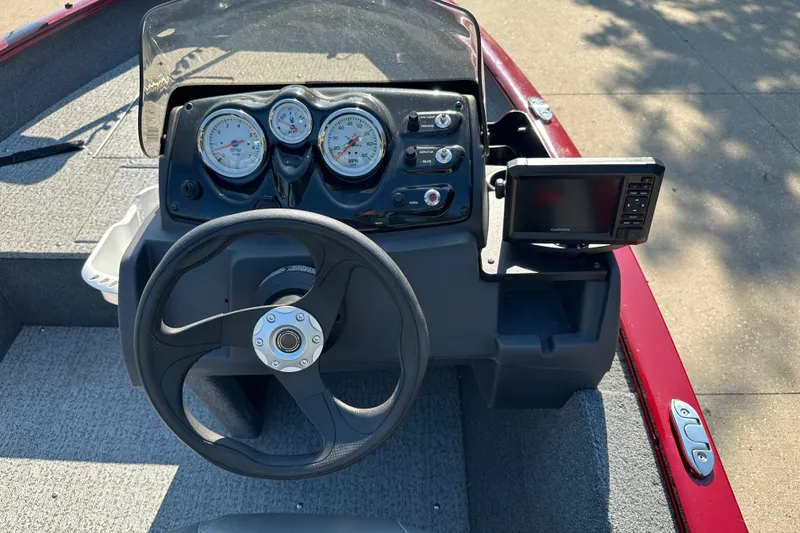 Slide: The Image of 2021 Tracker Super Guide V 16 SC boat dashboard with steering wheel and gauges. - 4