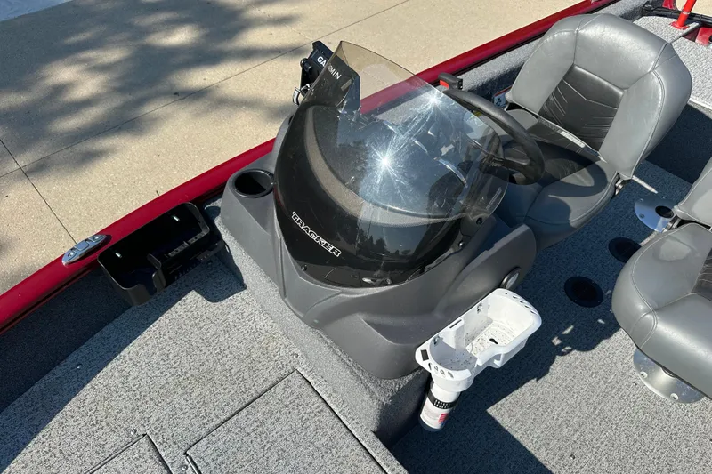 Slide: The Image of 2021 Tracker Super Guide V 16 SC boat interior with steering console and seats. - 6