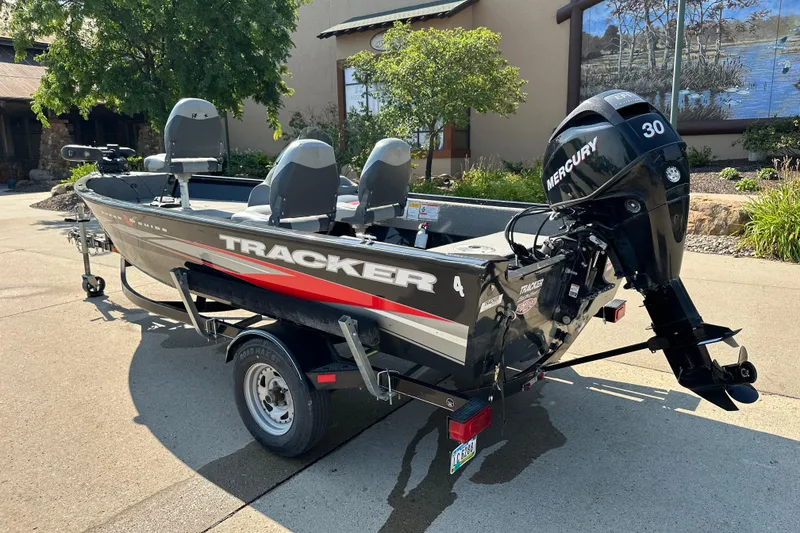 Slide: The Image of 2011 Tracker Super Guide V 16 SC boat with Mercury 30 engine on trailer. - 2