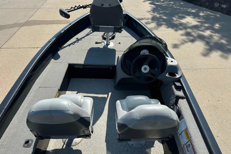 Slide: The Image of 2011 Tracker Super Guide V 16 SC boat interior with steering wheel and seating. - 4