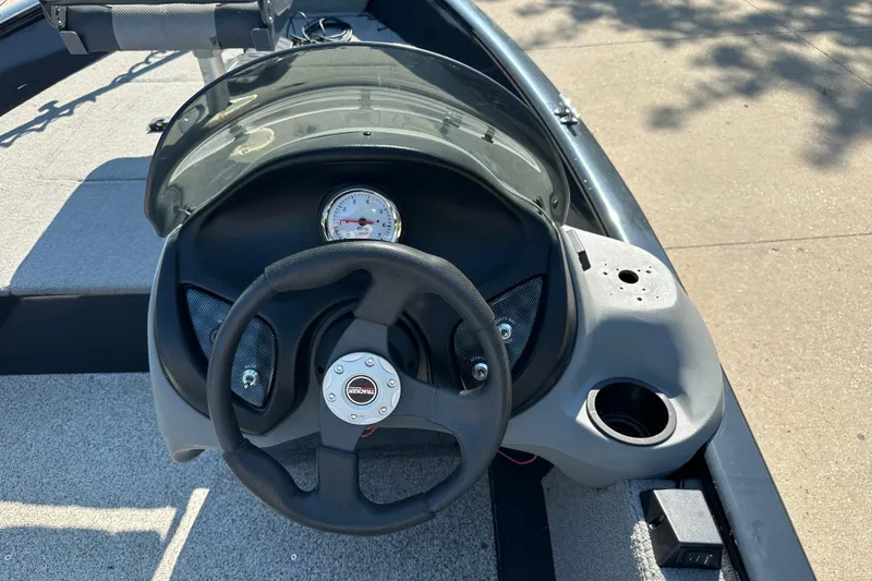 Slide: The Image of Steering console of 2011 Tracker Super Guide V 16 SC boat with gauge and cup holder. - 5