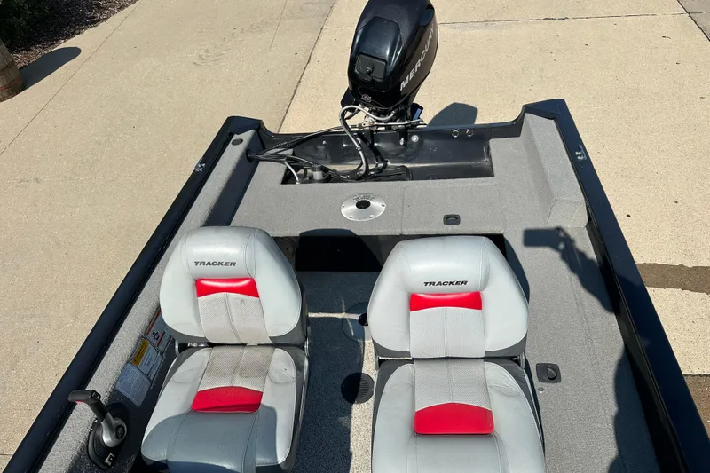 Slide: The Image of 2011 Tracker Super Guide V 16 SC boat interior with two seats and Mercury outboard motor. - 6