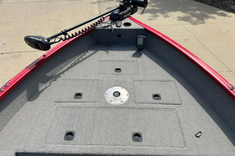 Slide: The Image of 2013 Tracker Pro Guide V 16 T boat deck with trolling motor and carpeted surface. - 3