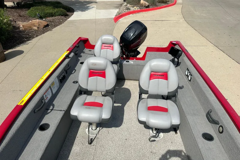 Slide: The Image of 2013 Tracker Pro Guide V 16 T boat interior with seating and motor. - 4