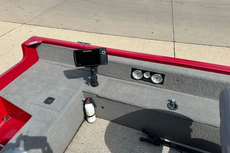 Slide: The Image of Interior of a 2013 Tracker Pro Guide V 16 T boat with gauges and a fish finder. - 5