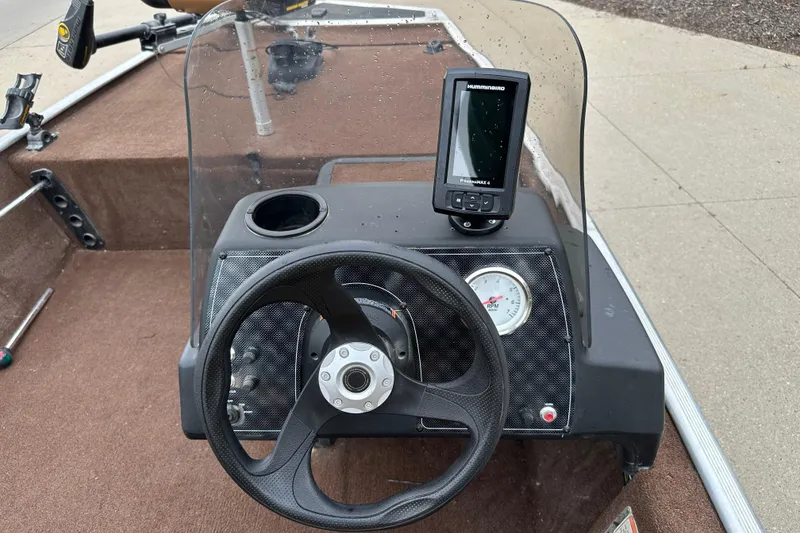Slide: The Image of 2018 Tracker Bass Tracker Classic XL dashboard with steering wheel and fish finder. - 4