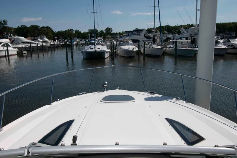 Slide: The Image of Bow view of 2007 Sea Ray 310 Sundancer docked in a marina. - 12