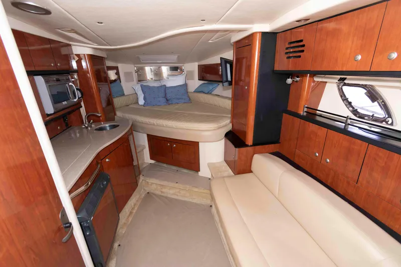 Slide: The Image of Luxurious interior of 2007 Sea Ray 310 Sundancer with wood cabinetry and cozy seating. - 14