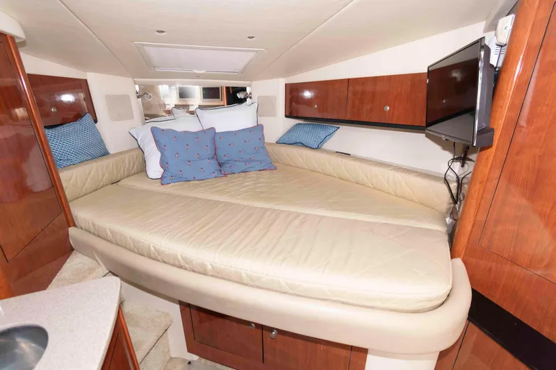 Slide: The Image of Luxurious cabin interior of 2007 Sea Ray 310 Sundancer with cozy bedding and wood finish. - 15