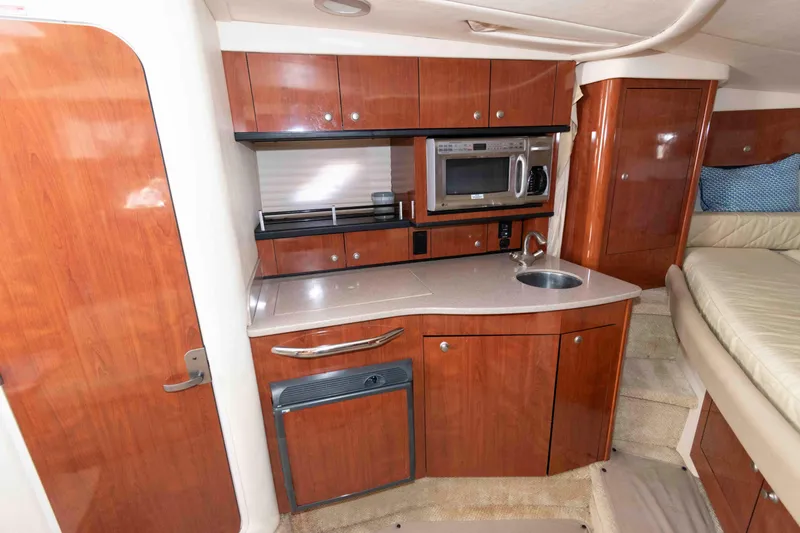 Slide: The Image of Interior of 2007 Sea Ray 310 Sundancer with kitchenette, microwave, and sink. - 16