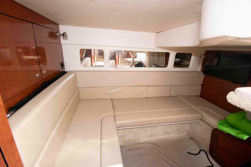 Slide: The Image of Interior of 2007 Sea Ray 310 Sundancer with beige seating and wooden cabinetry. - 18