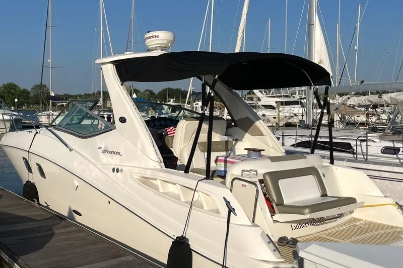 Slide: The Image of 2007 Sea Ray 310 Sundancer docked at marina with black canopy. - 2