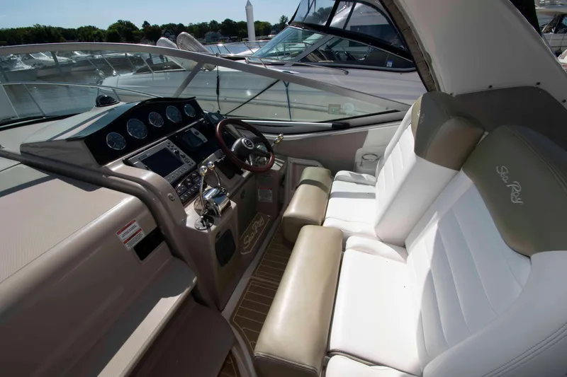 Slide: The Image of 2007 Sea Ray 310 Sundancer cockpit with steering wheel and control panel. - 7