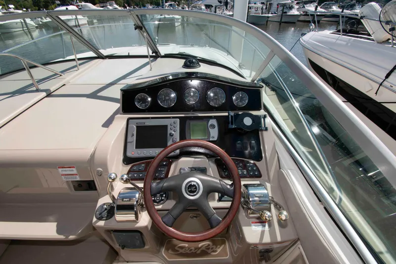 Slide: The Image of 2007 Sea Ray 310 Sundancer helm with steering wheel, gauges, and navigation equipment. - 8