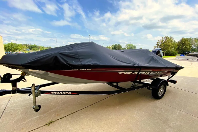 Slide: The Image of 2022 Tracker Pro Team 175 TXW boat with cover on trailer, parked outdoors. - 10