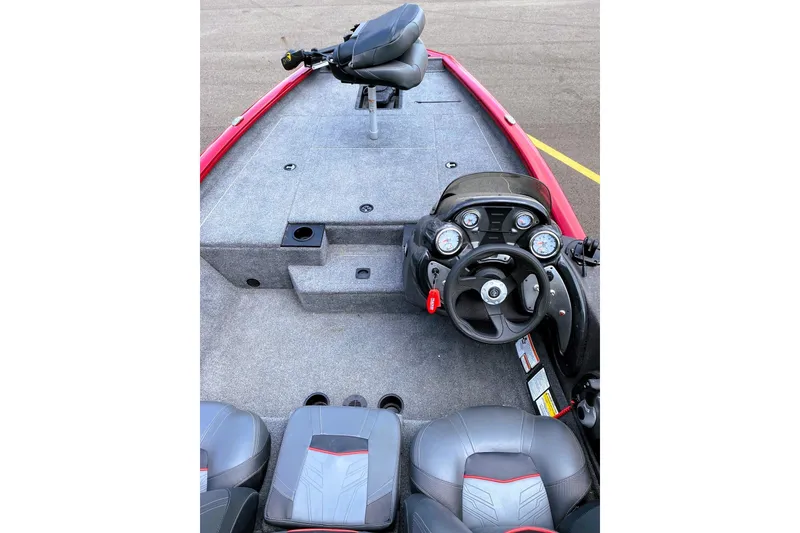 Slide: The Image of 2022 Tracker Pro Team 175 TXW boat interior with steering console and seating. - 4