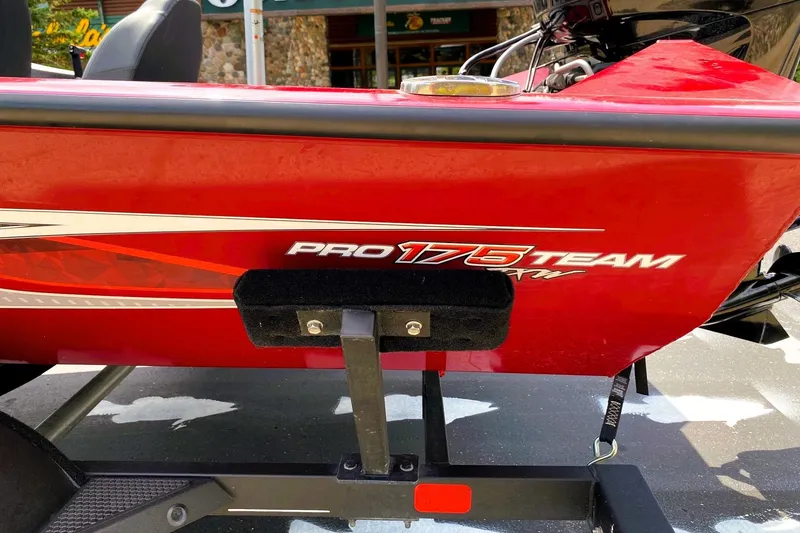 Slide: The Image of 2022 Tracker Pro Team 175 TXW boat, red exterior with logo, parked on trailer. - 6
