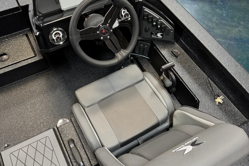 Slide: The Image of Interior of 2025 Xpress X19 Pro boat, featuring steering wheel and control panel. - 4