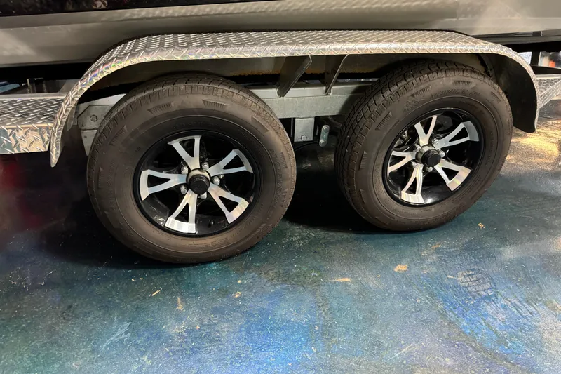 Slide: The Image of Dual wheels of 2025 Xpress X19 Pro trailer on a textured surface. - 9