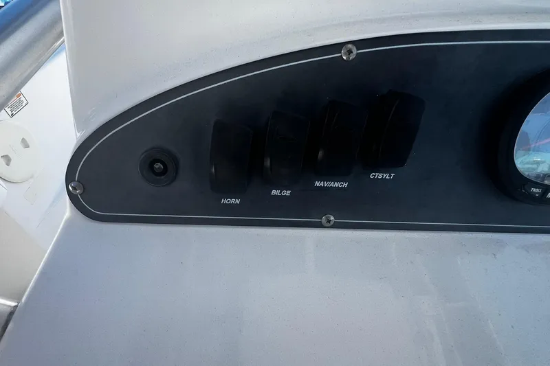 Slide: The Image of Control panel of a 2006 Boston Whaler 210 Outrage boat with labeled switches. - 18