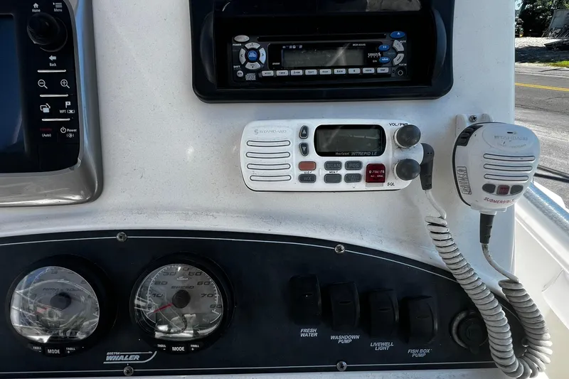 Slide: The Image of Dashboard of a 2006 Boston Whaler 210 Outrage boat with radio and controls. - 19