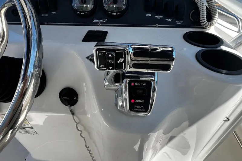 Slide: The Image of 2006 Boston Whaler 210 Outrage helm with steering wheel and throttle controls. - 20