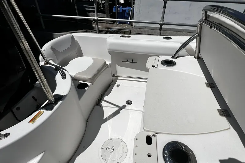 Slide: The Image of 2006 Boston Whaler 210 Outrage boat interior with seating and rod holders. - 22