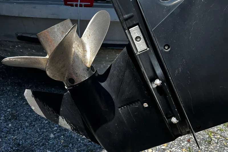 Slide: The Image of Close-up of a 2006 Boston Whaler 210 Outrage boat propeller on gravel. - 23
