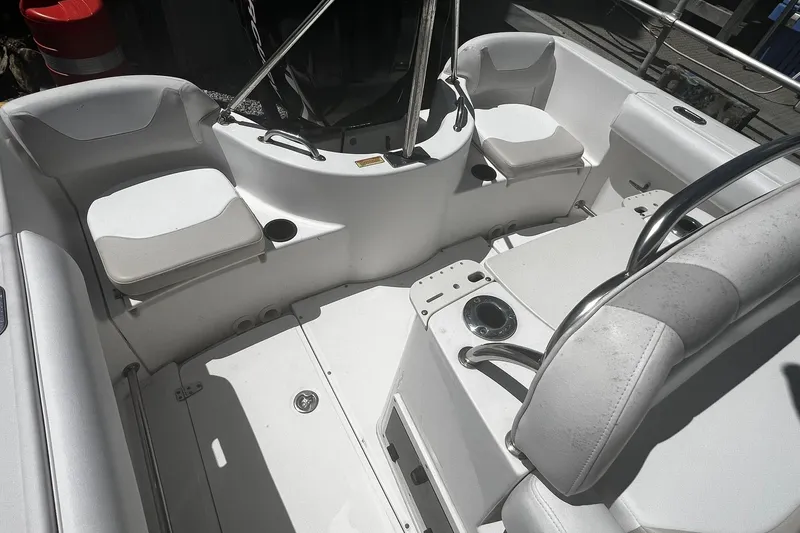 Slide: The Image of 2006 Boston Whaler 210 Outrage boat interior with seating and cup holders. - 4