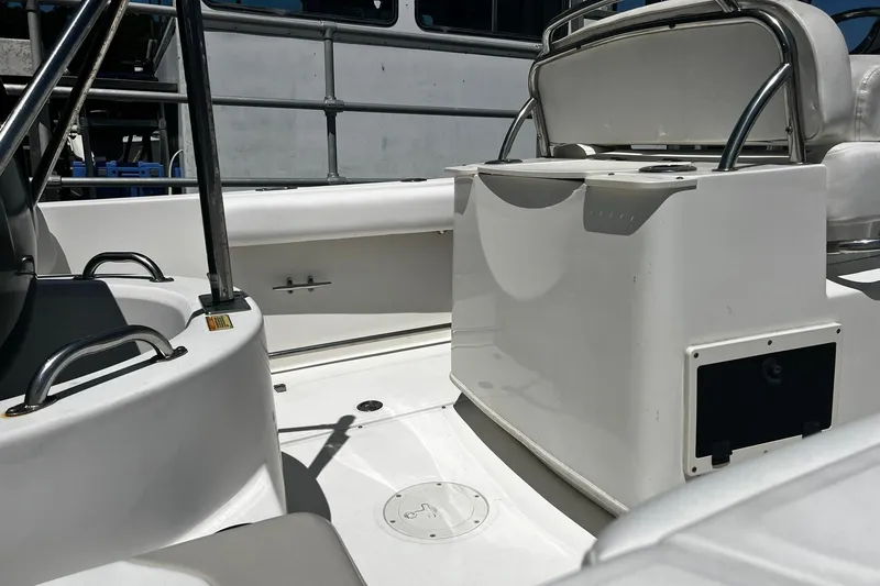 Slide: The Image of 2006 Boston Whaler 210 Outrage boat interior with seating and storage compartments. - 5