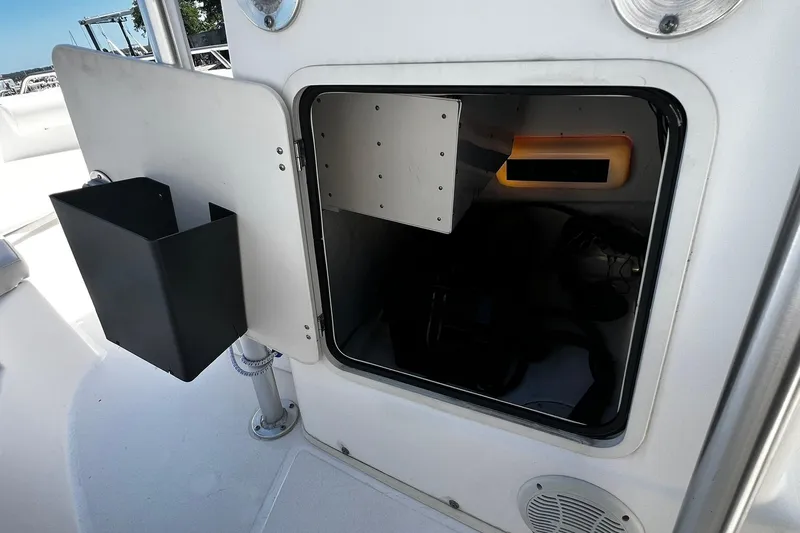 Slide: The Image of Open storage compartment on a 2006 Boston Whaler 210 Outrage boat interior. - 9