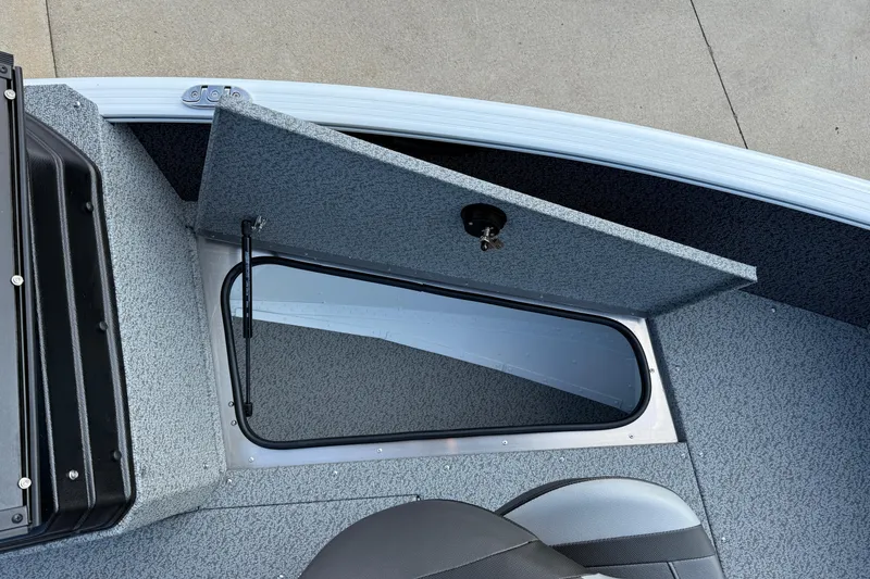 Slide: The Image of 2026 Lund 1675 Adventure Sport boat storage compartment with open hatch, showcasing interior design. - 11