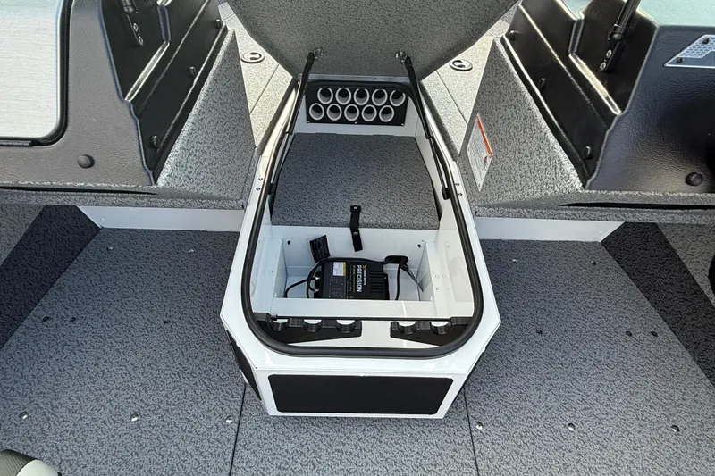 Slide: The Image of 2026 Lund 1675 Adventure Sport boat interior with open storage compartment and organized layout. - 14