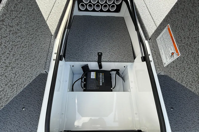 Slide: The Image of 2026 Lund 1675 Adventure Sport boat interior with storage compartment and battery charger. - 15