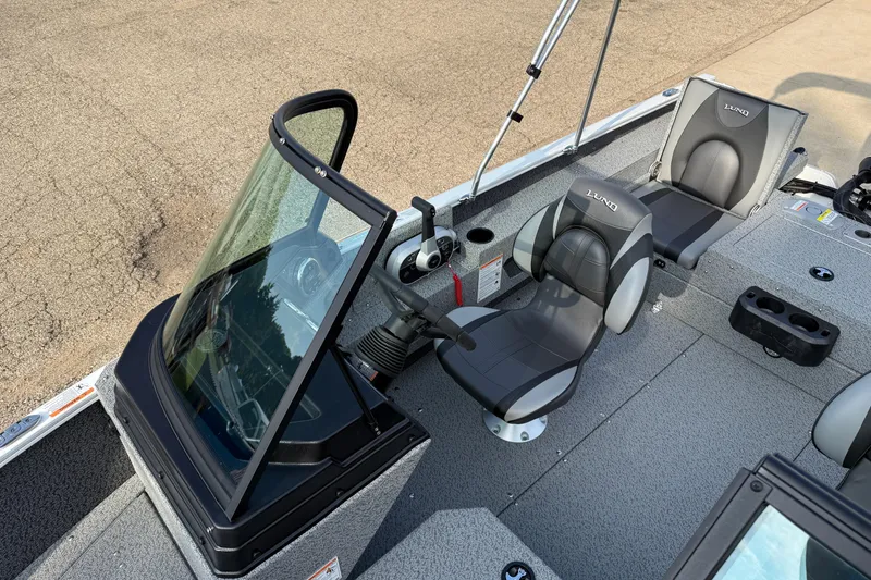 Slide: The Image of 2026 Lund 1675 Adventure Sport boat interior with seating and steering console. - 17