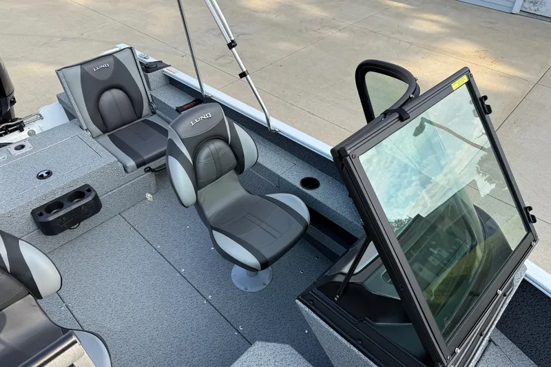 Slide: The Image of 2026 Lund 1675 Adventure Sport boat interior with gray seating and windshield. - 18