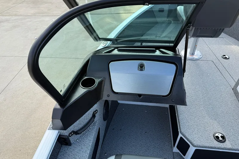 Slide: The Image of 2026 Lund 1675 Adventure Sport boat interior with windshield and storage compartment. - 22