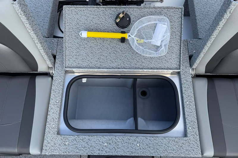 Slide: The Image of 2026 Lund 1675 Adventure Sport boat interior with storage compartment and fishing gear. - 26