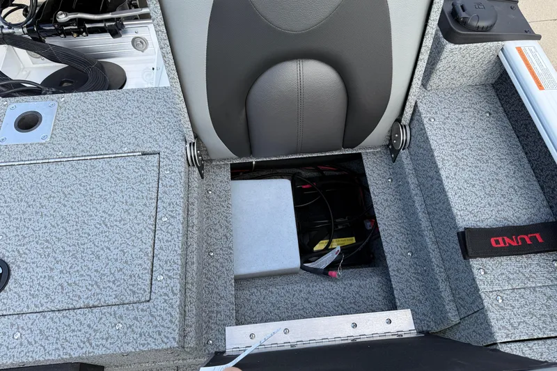 Slide: The Image of 2026 Lund 1675 Adventure Sport boat interior with storage compartment and seat. - 27