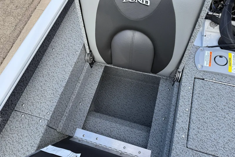 Slide: The Image of 2026 Lund 1675 Adventure Sport boat interior with storage compartment and seating. - 28