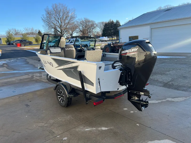Slide: The Image of 2026 Lund 1675 Adventure Sport boat on trailer outside showroom. - 4