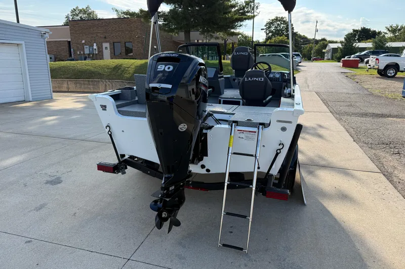 Slide: The Image of 2026 Lund 1675 Adventure Sport boat with Mercury 90 engine, parked outdoors. - 8