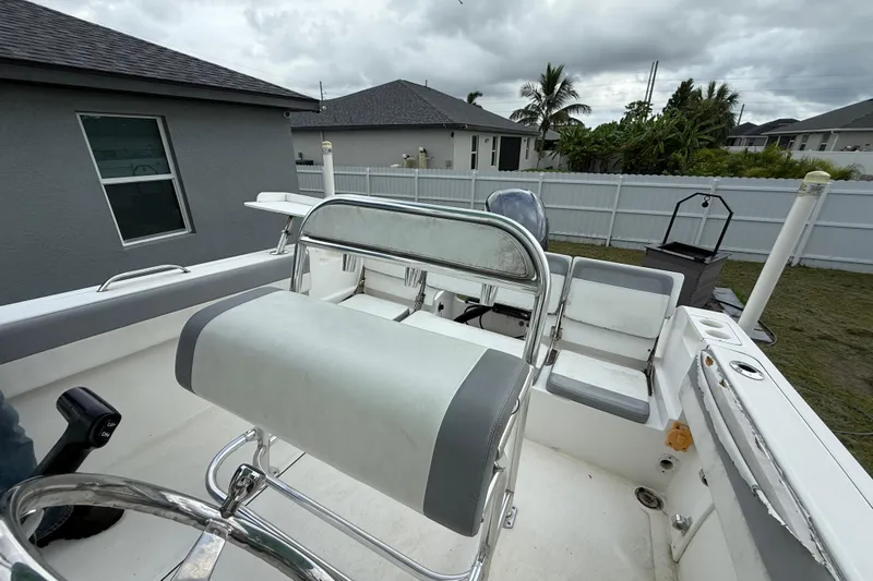Slide: The Image of 2018 Release 208 RX boat interior with seating, steering wheel, and overcast sky. - 19