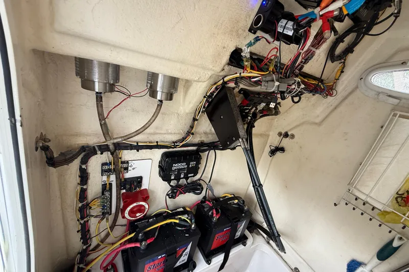 Slide: The Image of Electrical system inside a 2018 Release 208 RX boat, featuring batteries and wiring. - 21