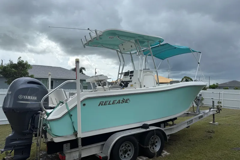 Slide: The Image of 2018 Release 208 RX boat on trailer with Yamaha engine, parked in a grassy yard. - 27